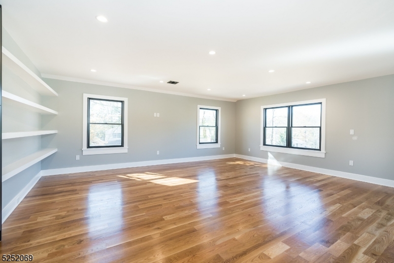 76 Burnet Road, Unit 2 Florham Park, NJ 07940 - Photo 10 of 24 an empty room with wooden floor and windows
