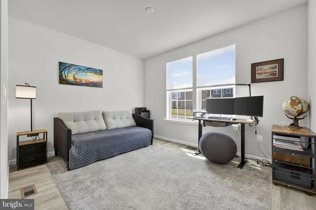 a kitchen with a sink and chairs