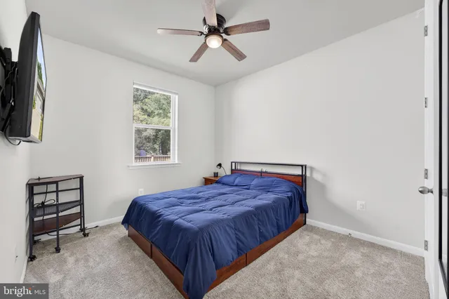 a room with furniture pool table wooden floor and a window