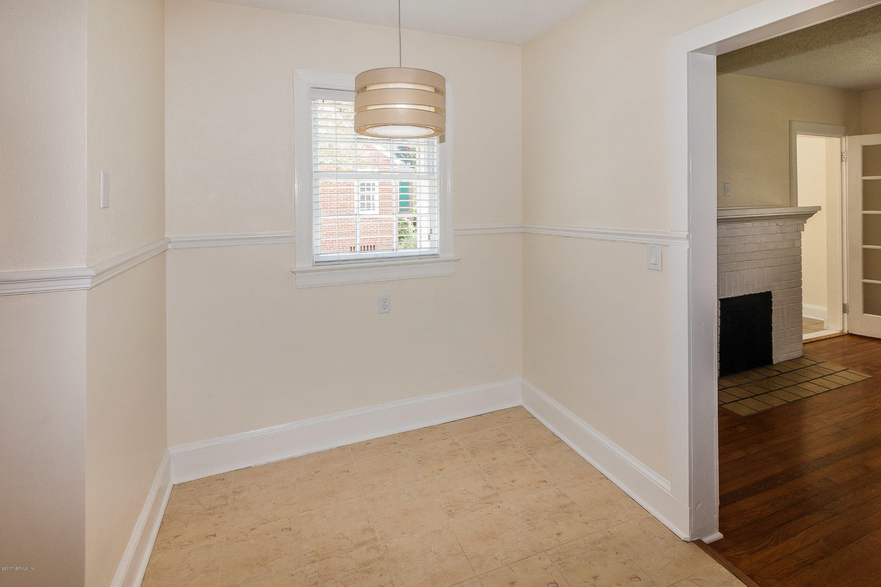 1053 Old Hickory Road Jacksonville, FL 32207 - Photo 8 of 25 an empty room with wooden floor fireplace and windows