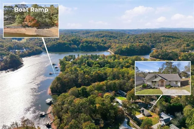 a front view of a house with a yard and potted plants