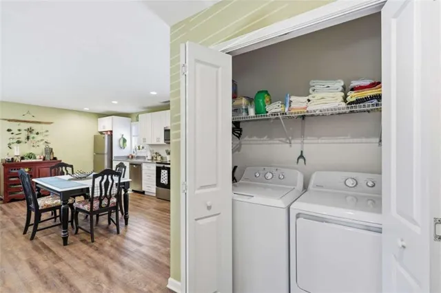 a view of dining room and kitchen with furniture and wooden floor