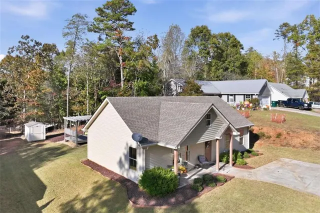 an aerial view of a house with swimming pool and sitting area