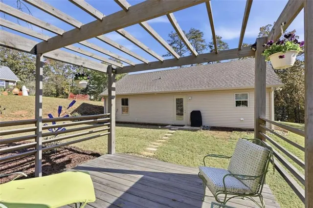 a view of a patio with table and chairs and wooden floor