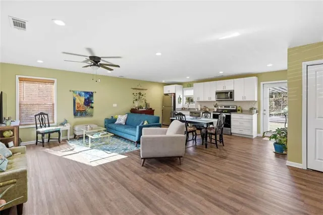 a living room with furniture and kitchen view