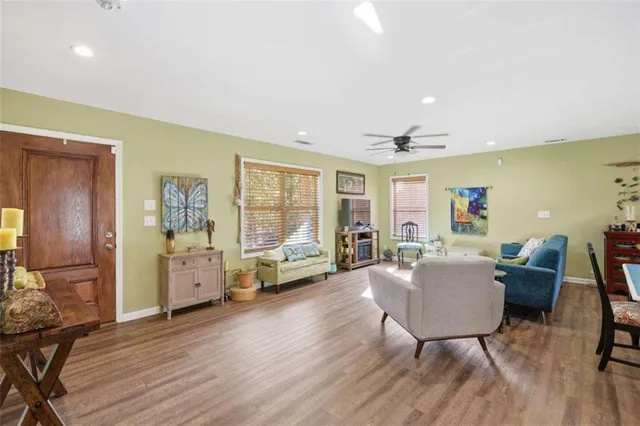 a living room with furniture and wooden floor