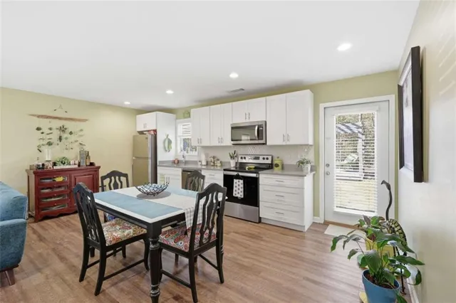 a view of a dining room with furniture and wooden floor