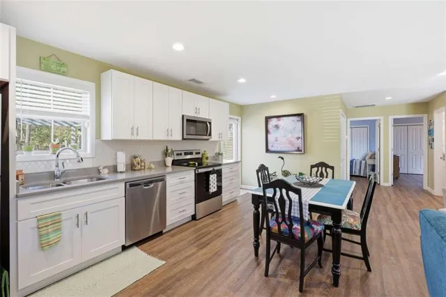 a view of kitchen with cabinets table and chairs