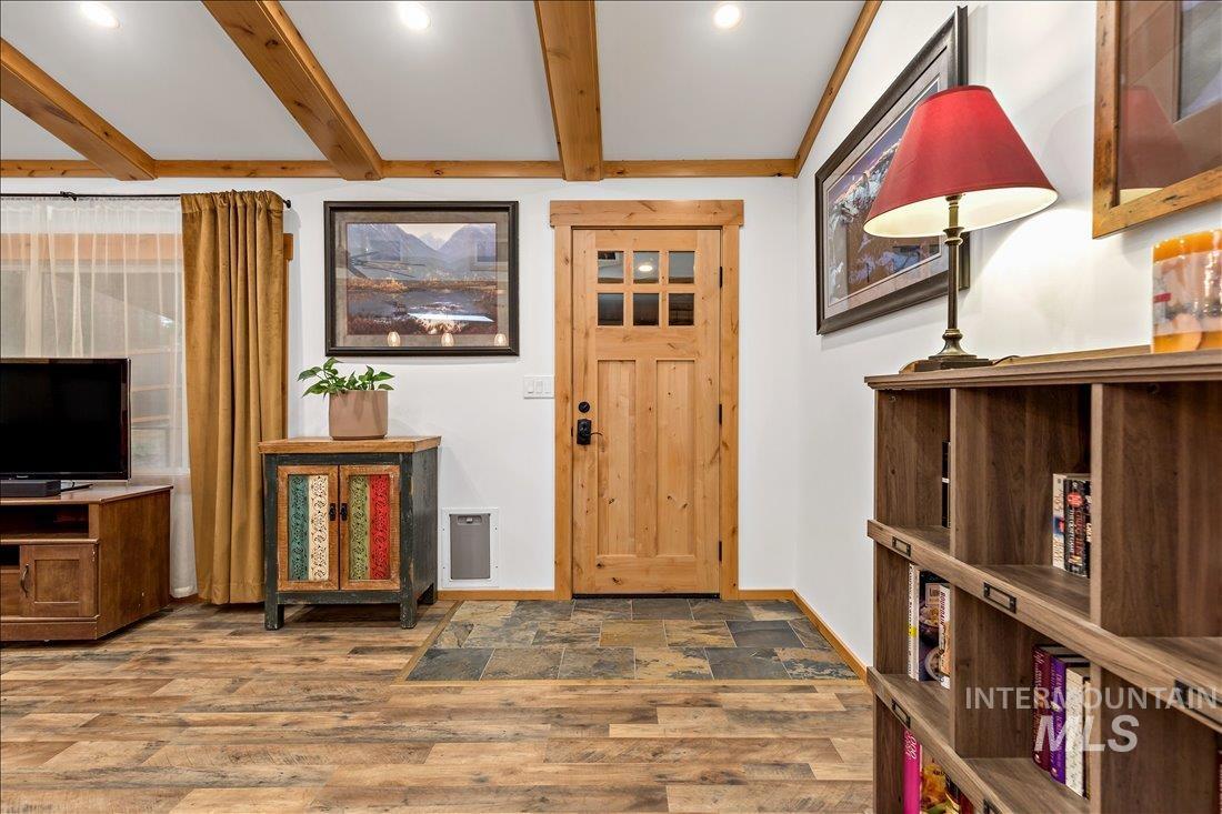 79 Sunset Loop Cascade, ID 83611 - Photo 4 of 44 Wood-finish flooring throughout, featuring exposed ceiling beams and recessed lighting