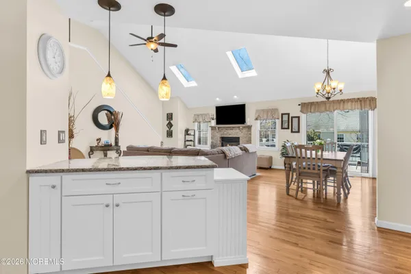 a living room with granite countertop furniture a fireplace and wooden floor