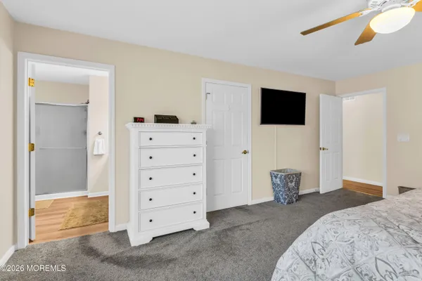 a view of bedroom with furniture and flat screen tv