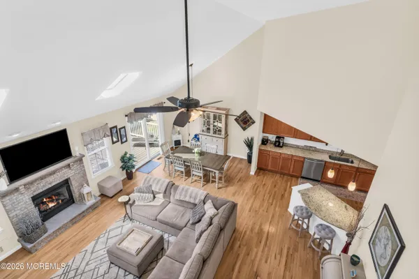 a living room with furniture a flat screen tv and a wooden floor