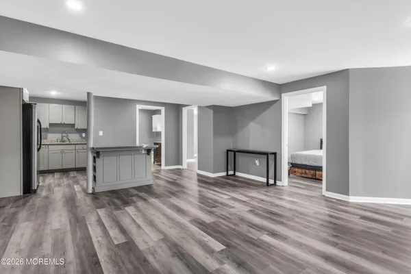 a living room with stainless steel appliances kitchen island wooden floor and view living room