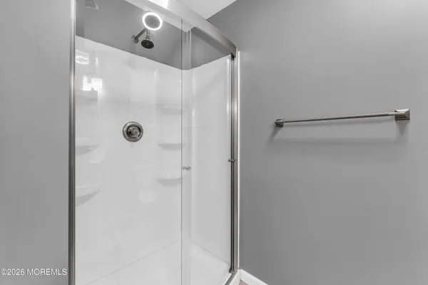 a bathroom with a glass shower door