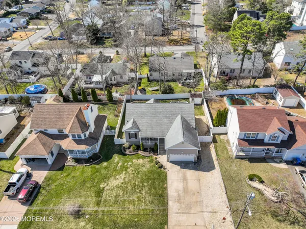 an aerial view of residential houses with outdoor space and parking