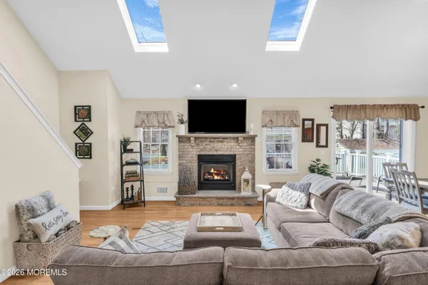 a living room with furniture a fireplace and a flat screen tv