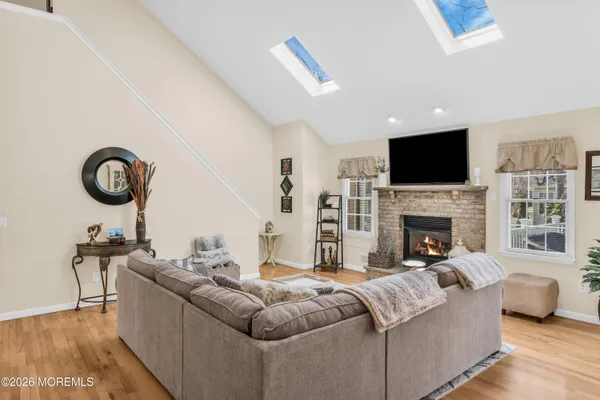 a living room with furniture a fireplace and a flat screen tv