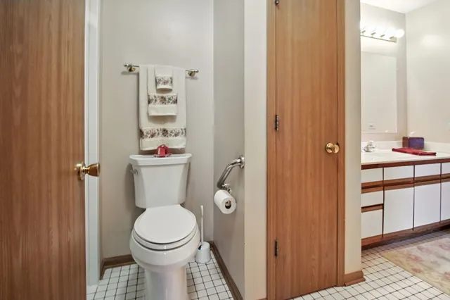 a white toilet sitting next to a bathroom sink
