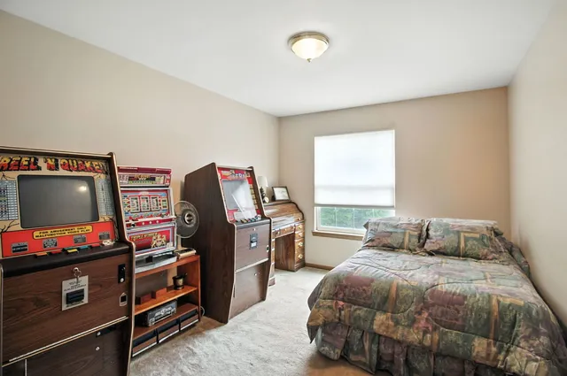 a bedroom with a bed and flat screen tv