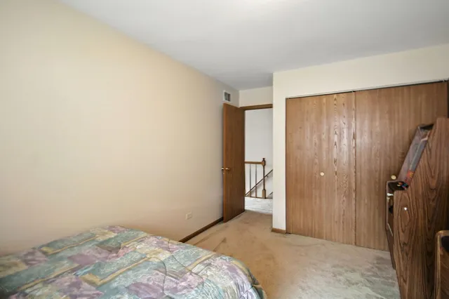 a bedroom with a bed and a bathroom