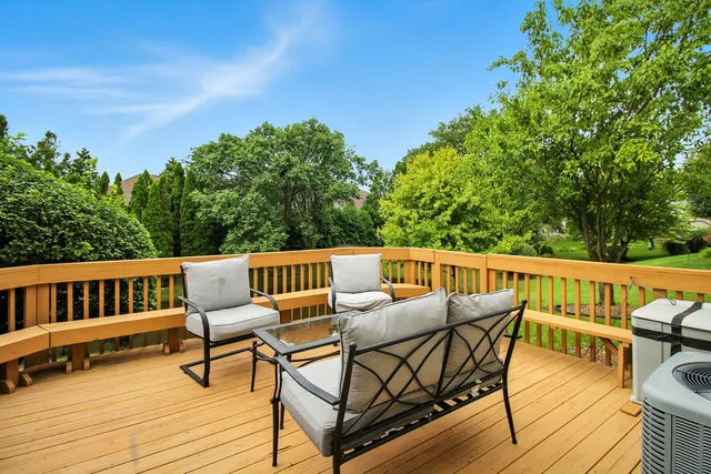 a view of a chairs and table on the roof deck