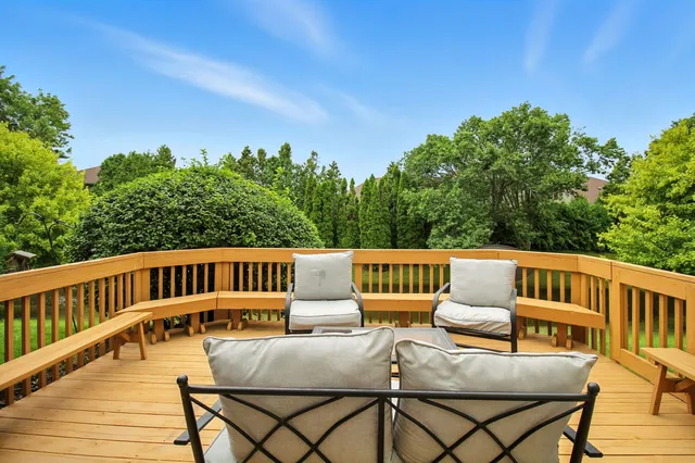a balcony with wooden floor outdoor seating and city view