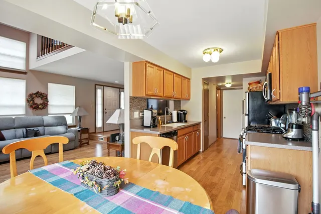 a living room with furniture a fireplace and a chandelier