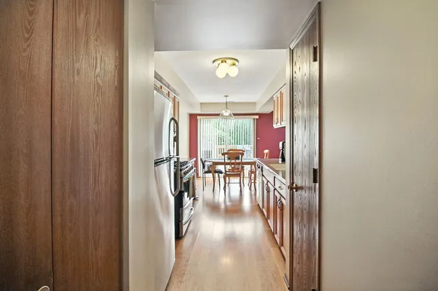 a view of a hallway with furniture and floor to ceiling window