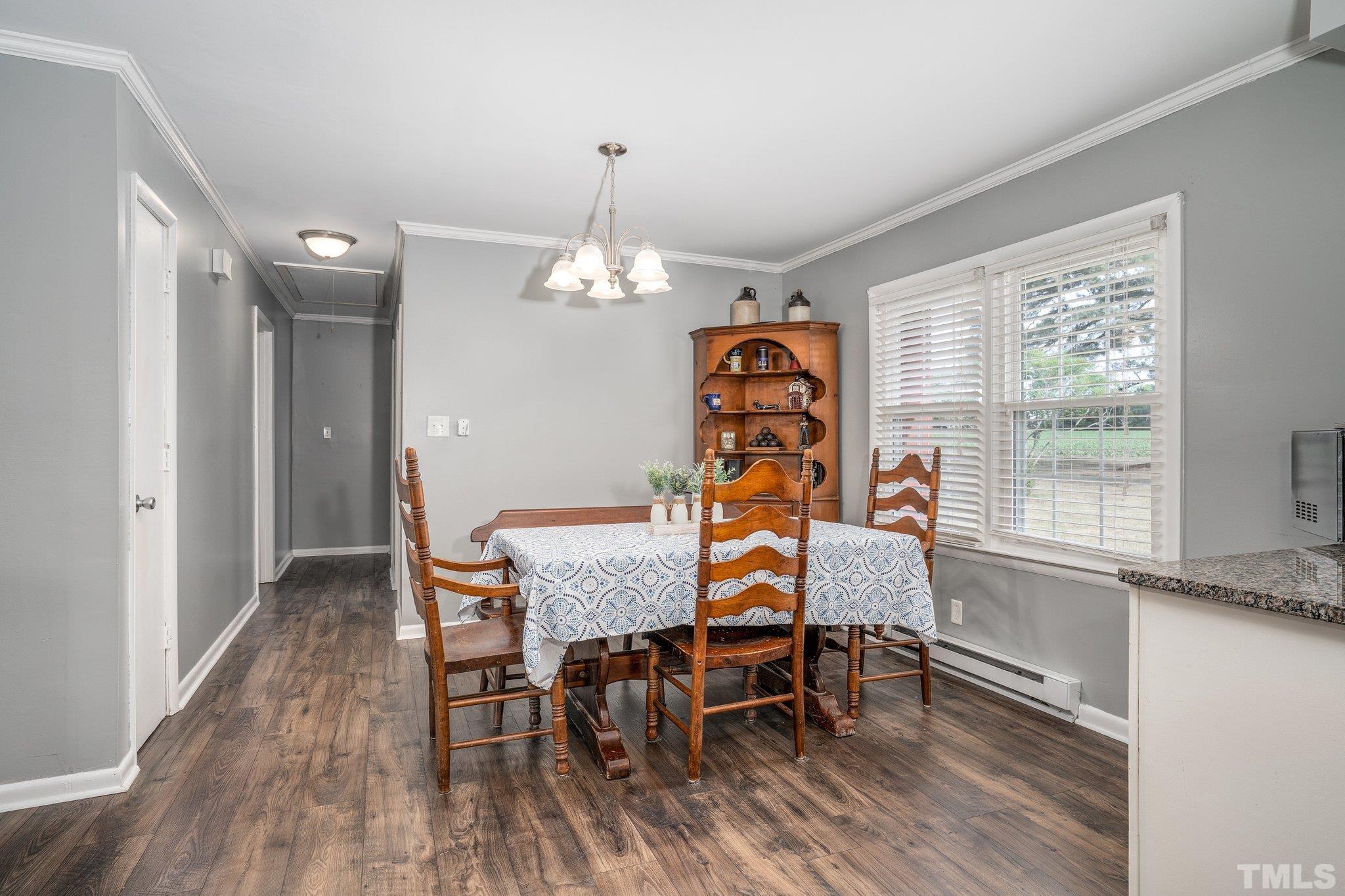 617 3rd Street Spring Hope, NC 27882 - Photo 11 of 23 a dining room with furniture a chandelier and wooden floor