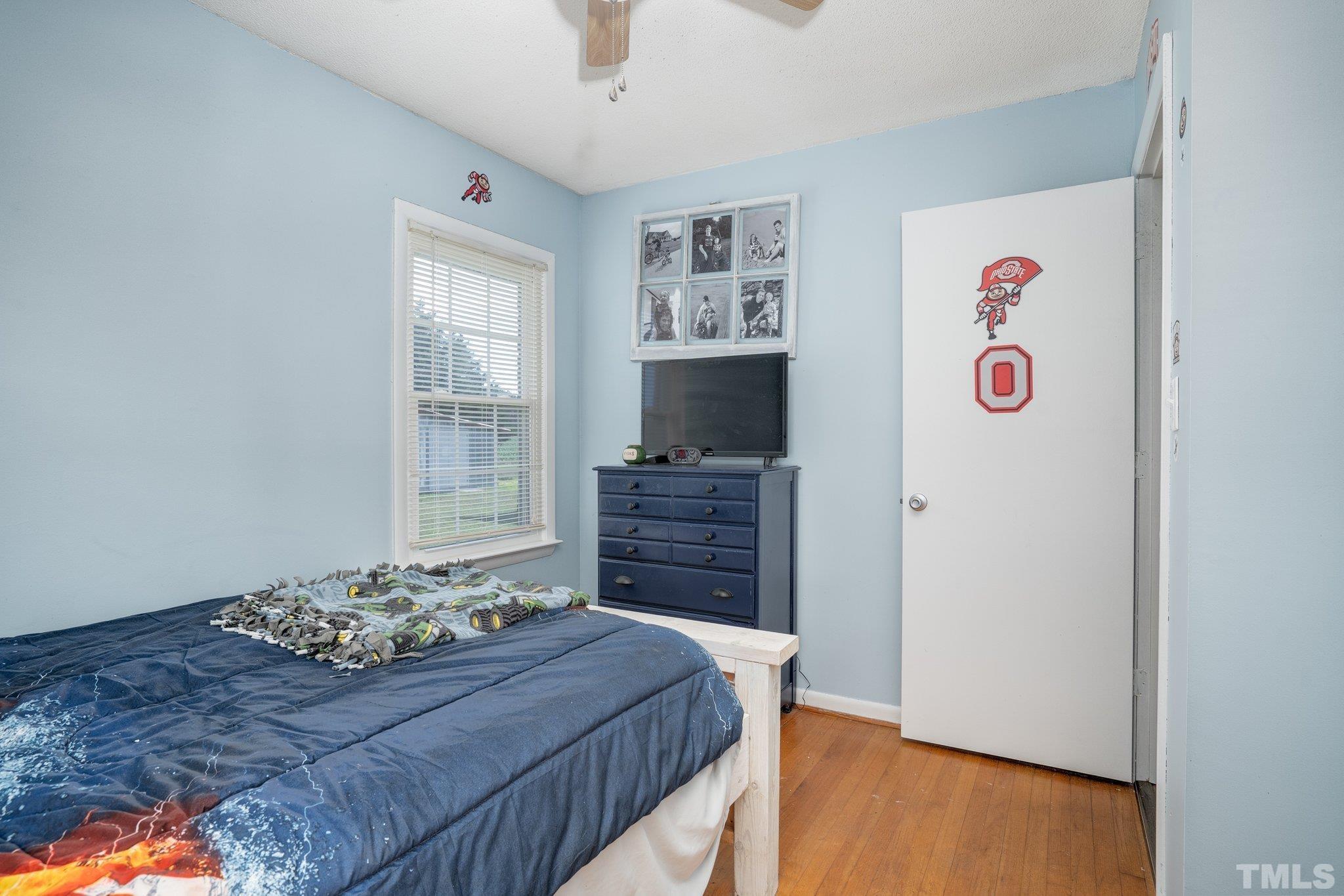 617 3rd Street Spring Hope, NC 27882 - Photo 3 of 23 a bedroom with a bed and a television