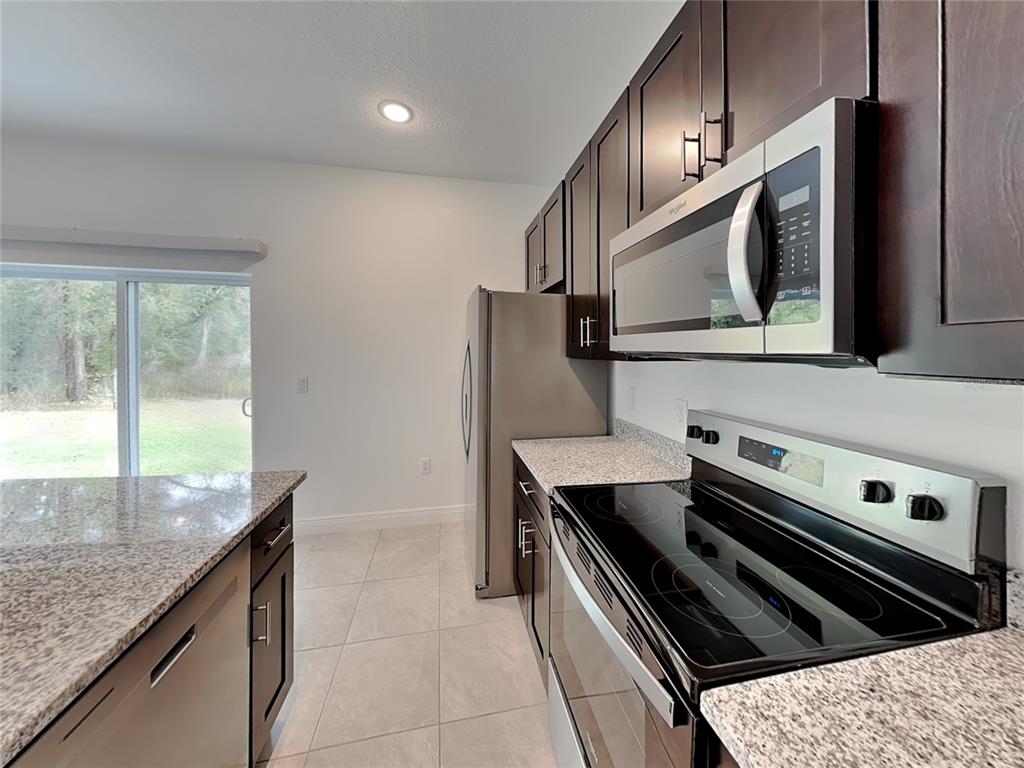8809 North Sandree Drive Citrus Springs, FL 34434 - Photo 3 of 16 a kitchen with a stove and a microwave