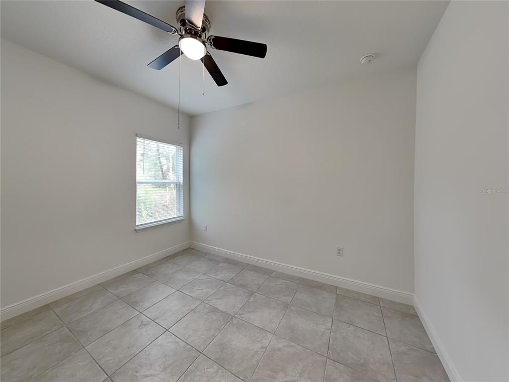 8809 North Sandree Drive Citrus Springs, FL 34434 - Photo 10 of 16 an empty room with windows and fan
