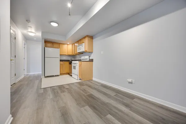 a view of a kitchen with a sink and a refrigerator