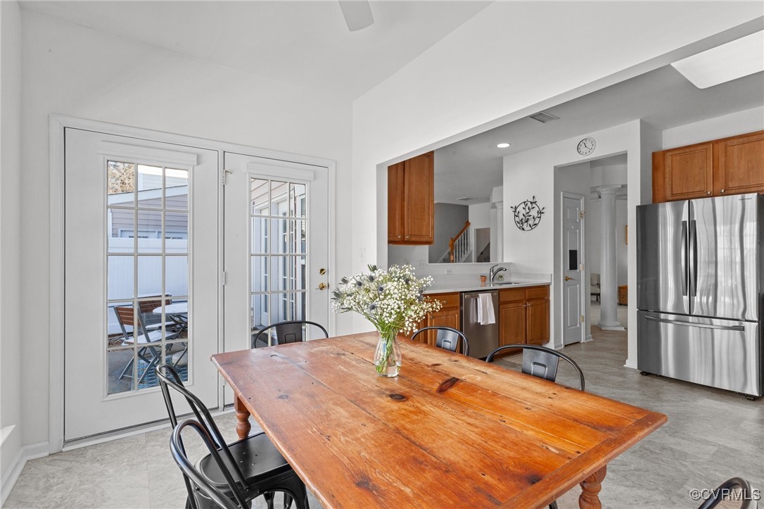 4405 Acoma Circle Williamsburg, VA 23188 - Photo 11 of 44 a dining table with a stove a refrigerator and a kitchen view with wooden floor