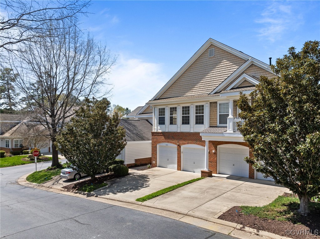 4405 Acoma Circle Williamsburg, VA 23188 - Photo 2 of 44 a front view of a house with garden