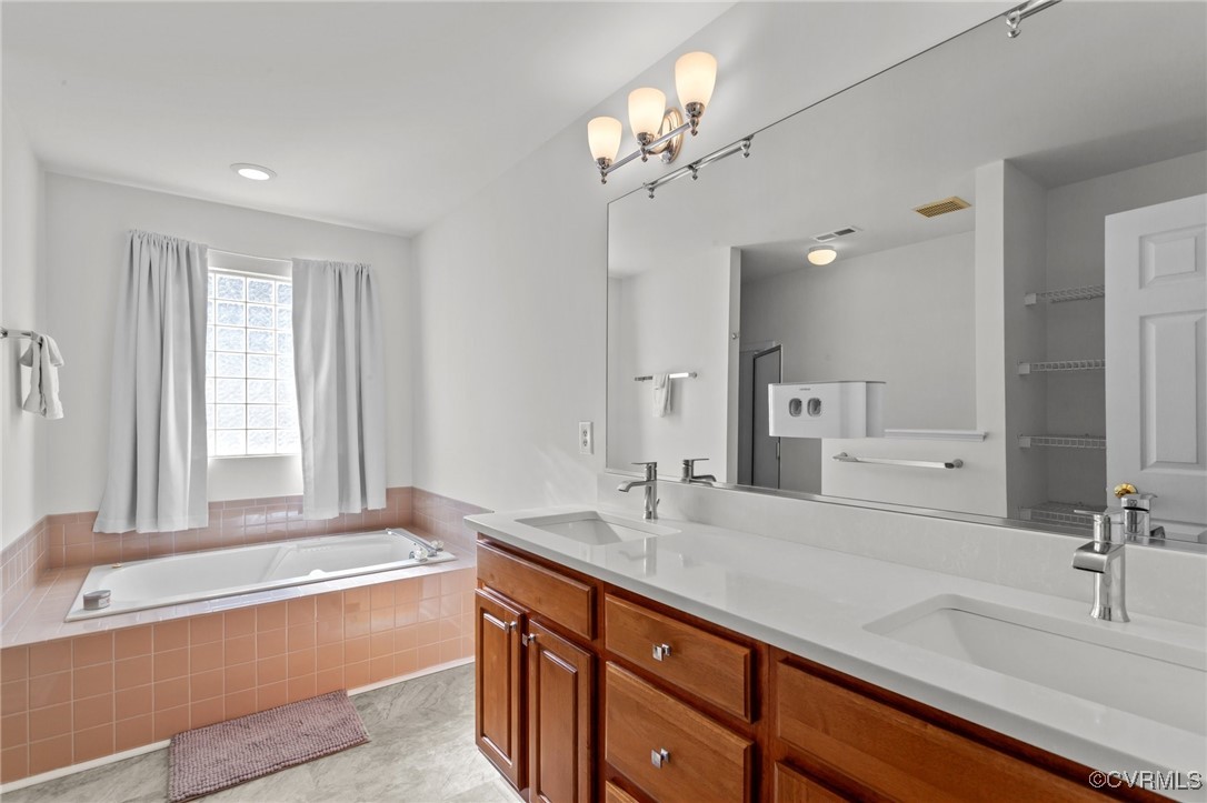 4405 Acoma Circle Williamsburg, VA 23188 - Photo 31 of 44 a bathroom with a tub sink and mirror