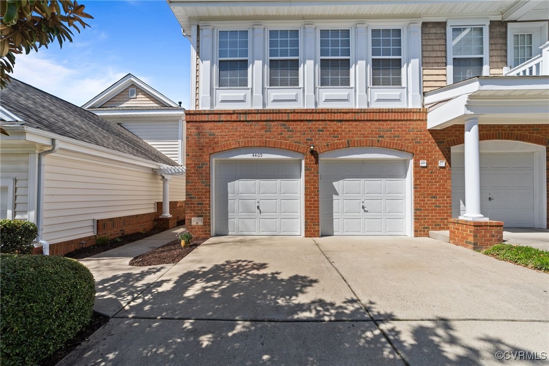 4405 Acoma Circle Williamsburg, VA 23188 - Photo 43 of 44 a front view of a house with a yard and garage