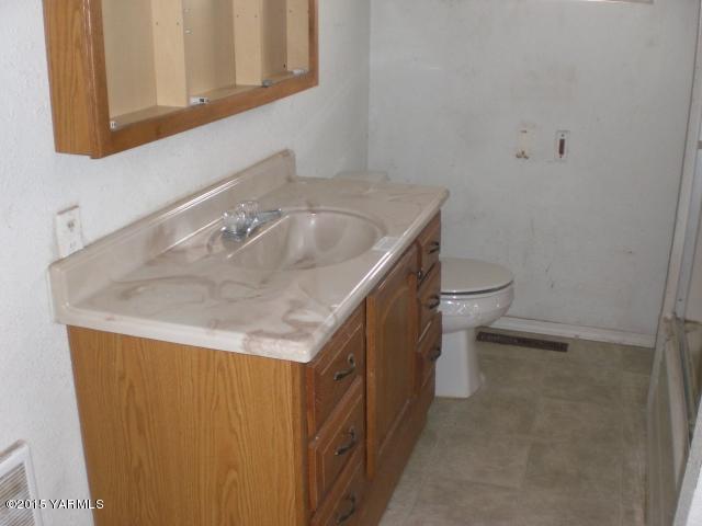 330 South Satus Road Toppenish, WA 98948 - Photo 6 of 24 a bathroom with a sink and a toilet