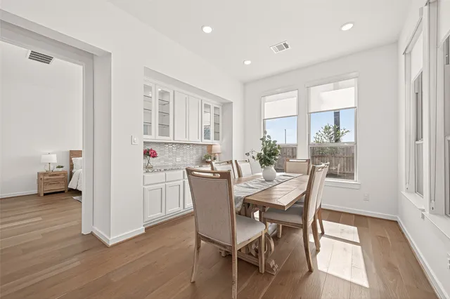 a view of a dining room with furniture and wooden floor
