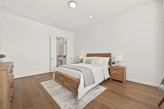 a bedroom with a bed and a night stand