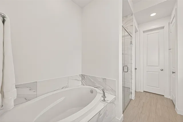 a bathroom with a tub and shower