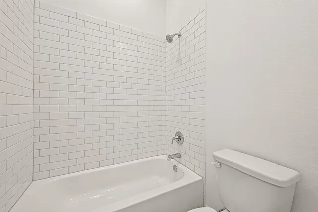 a bathroom with a bathtub and toilet
