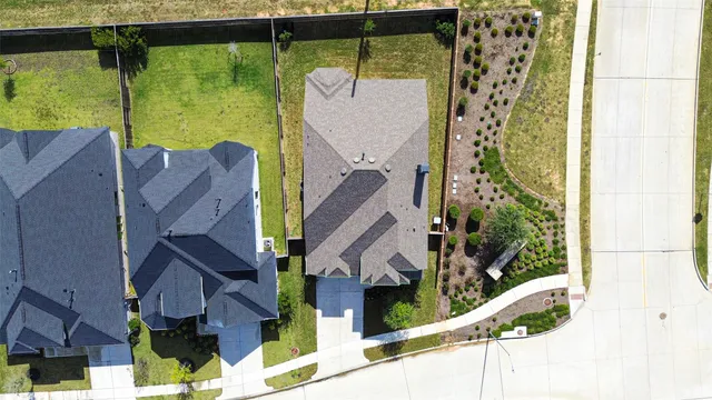 a view of a house with a small yard and a wooden fence