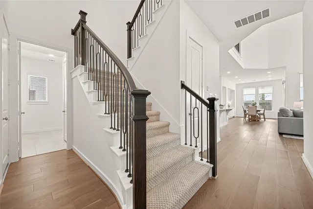 a view of entryway and hall with wooden floor