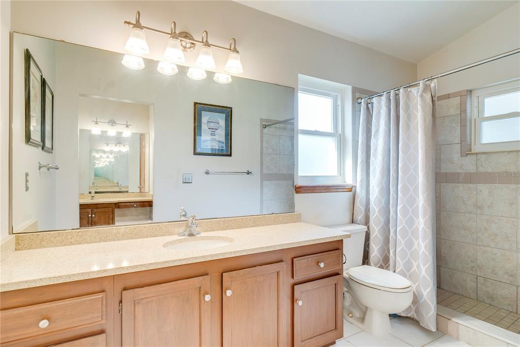 1504 East Spring Ridge Circle Winter Garden, FL 34787 - Photo 13 of 21 a bathroom with a double vanity sink toilet and a mirror