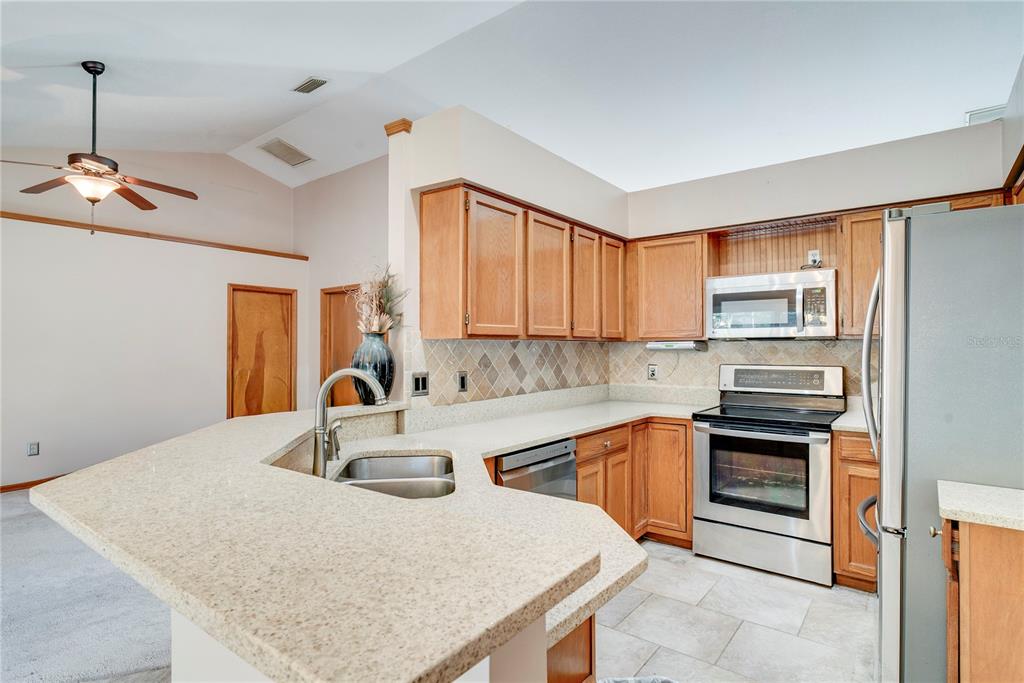 1504 East Spring Ridge Circle Winter Garden, FL 34787 - Photo 7 of 21 a kitchen with a sink a stove and oven
