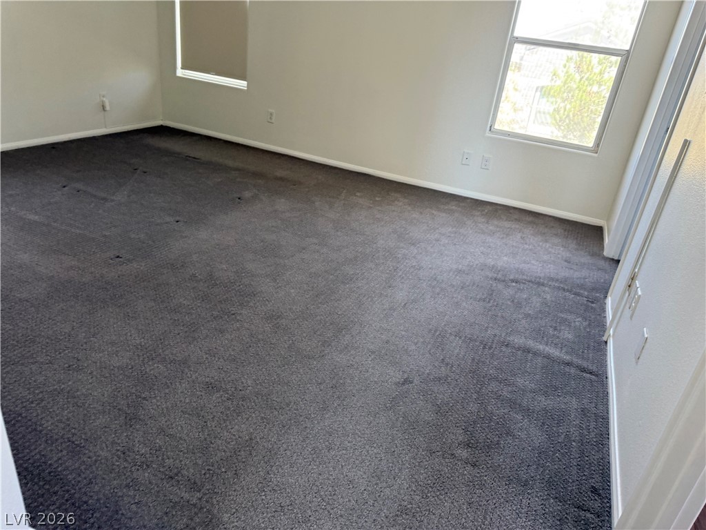 1141 Cathedral Ridge Street Henderson, NV 89052 - Photo 45 of 77 Bright and airy room with plush carpeting and natural light filtering through the windows.