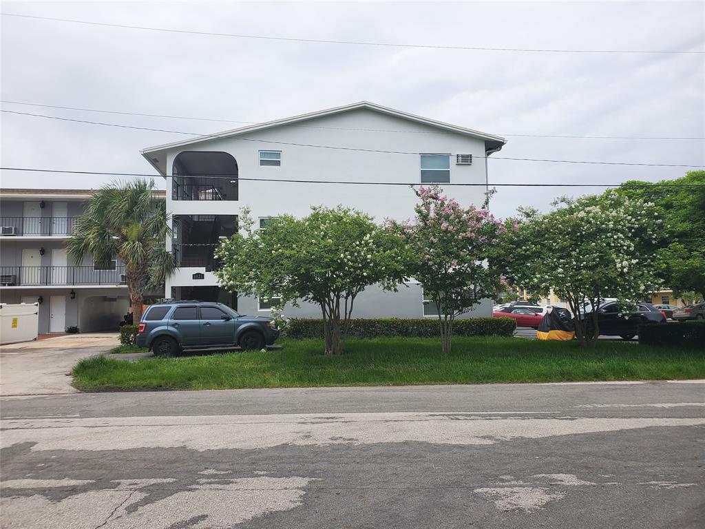 1021 Northeast 24th Avenue, Unit 4 Pompano Beach, FL 33062 - Photo 16 of 21 a house that has a tree in front of it
