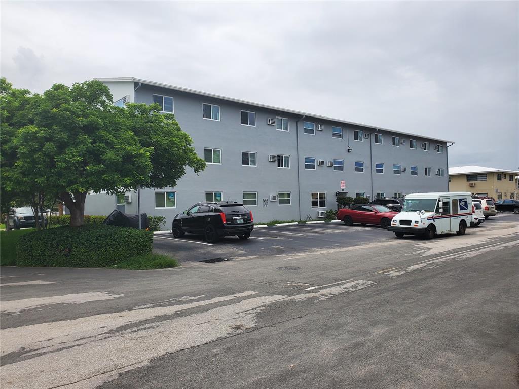 1021 Northeast 24th Avenue, Unit 4 Pompano Beach, FL 33062 - Photo 17 of 21 a view of street with parked cars