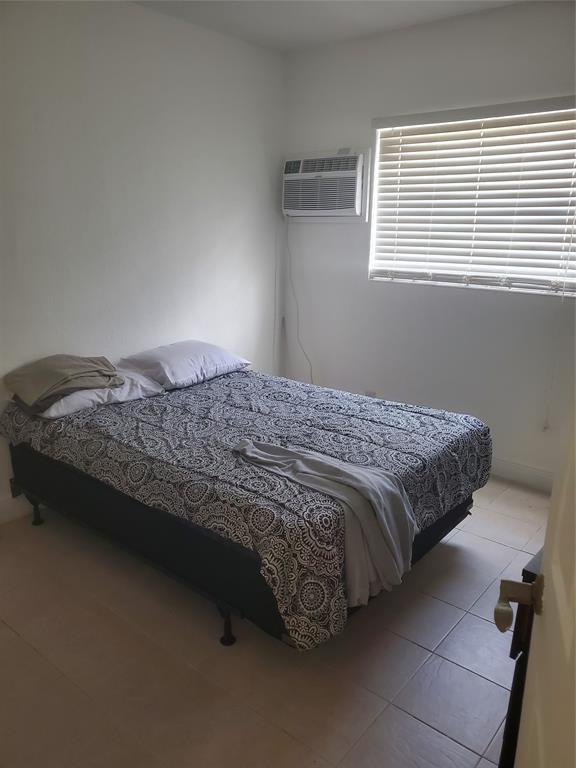 1021 Northeast 24th Avenue, Unit 4 Pompano Beach, FL 33062 - Photo 9 of 21 a bedroom with a bed and a window